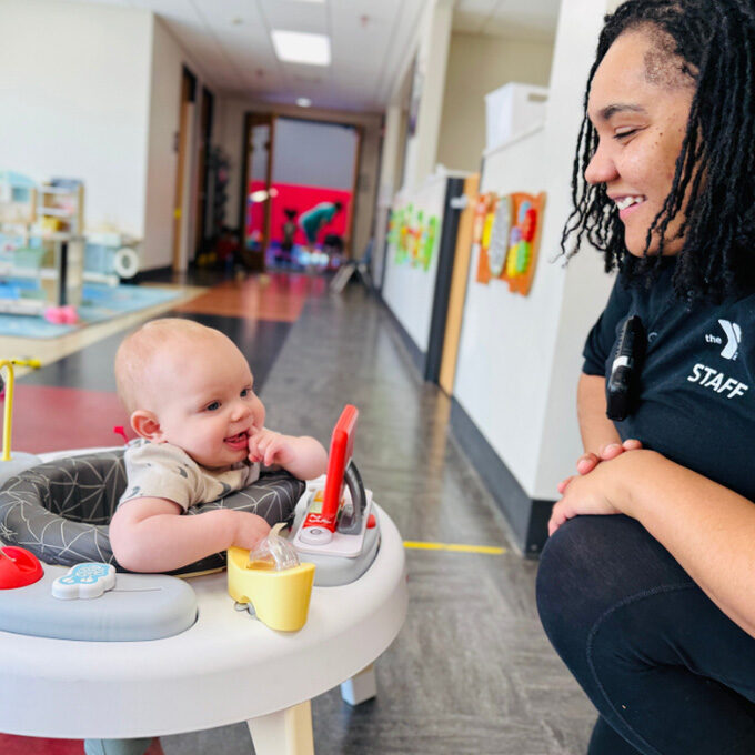 Staff member with baby in child watch